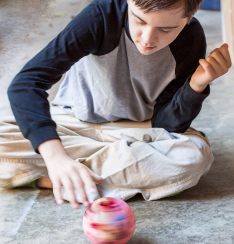 boy spinning small ball